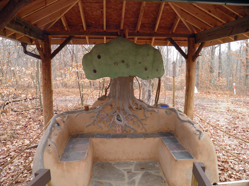 sculpture of a tree made from clay, sand and straw