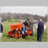 Photograph of the tree planter in operation.  Pulled by a tractor.