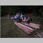 observers sitting on a stack of freshly sawn lumber