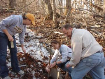 students preparing a pitfall trap for salamanders